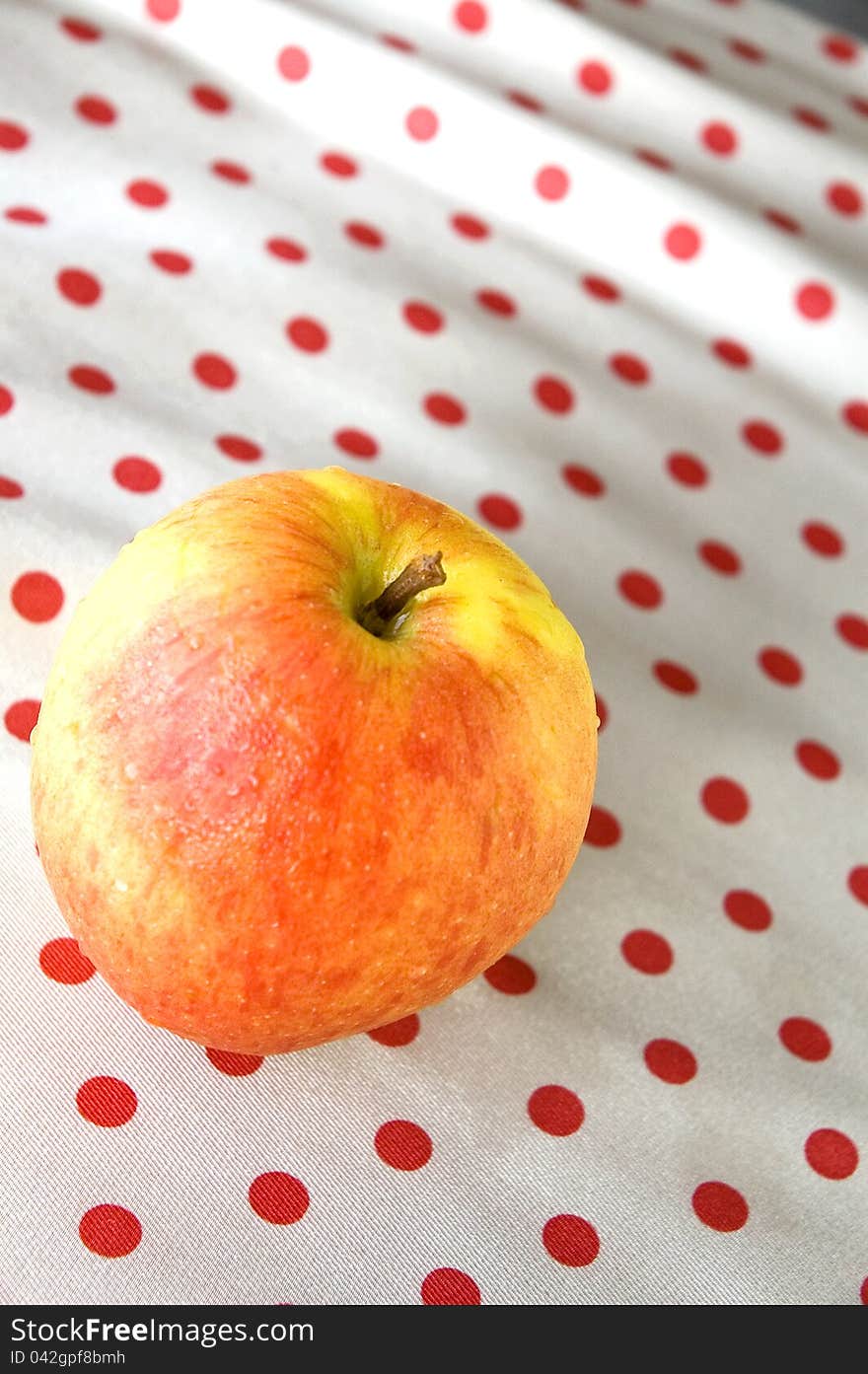 Apple on polka dots background