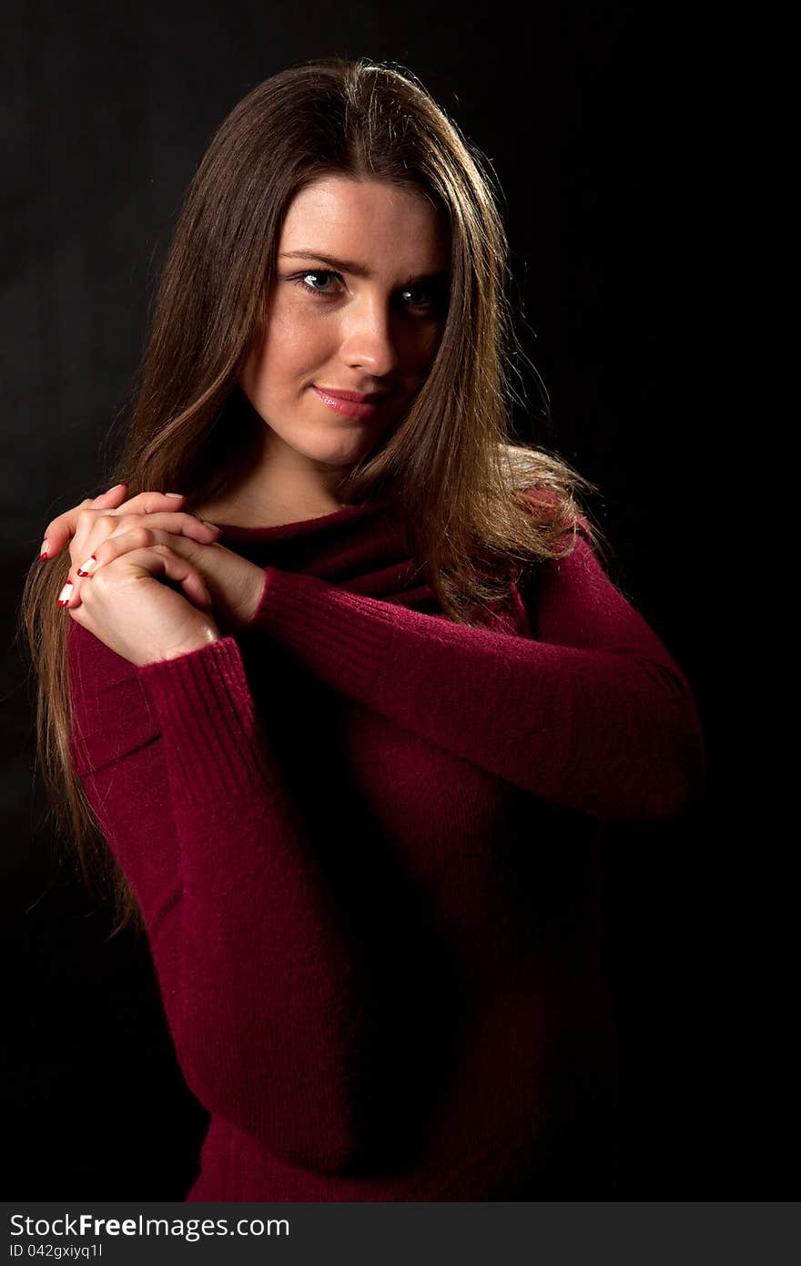 Portrait of the young girl on a black background