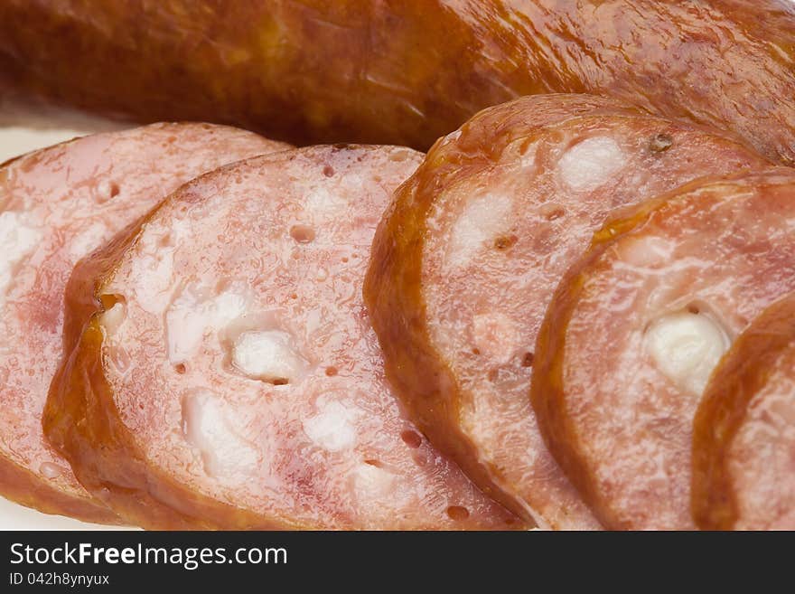 Sliced sausage on a white background isolated. This has a clipping path. Sliced sausage on a white background isolated. This has a clipping path.