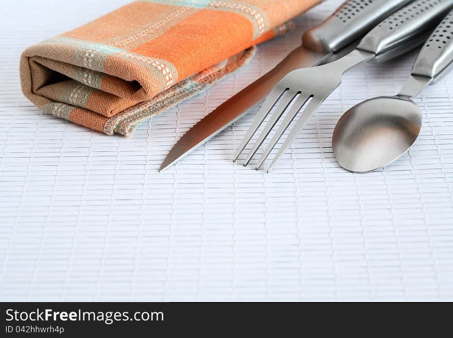 Closeup of cover set near checkered napkin. Closeup of cover set near checkered napkin