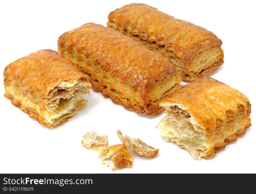 Vanilla and cocoa flaky cookies with crumbs isolated on a white background