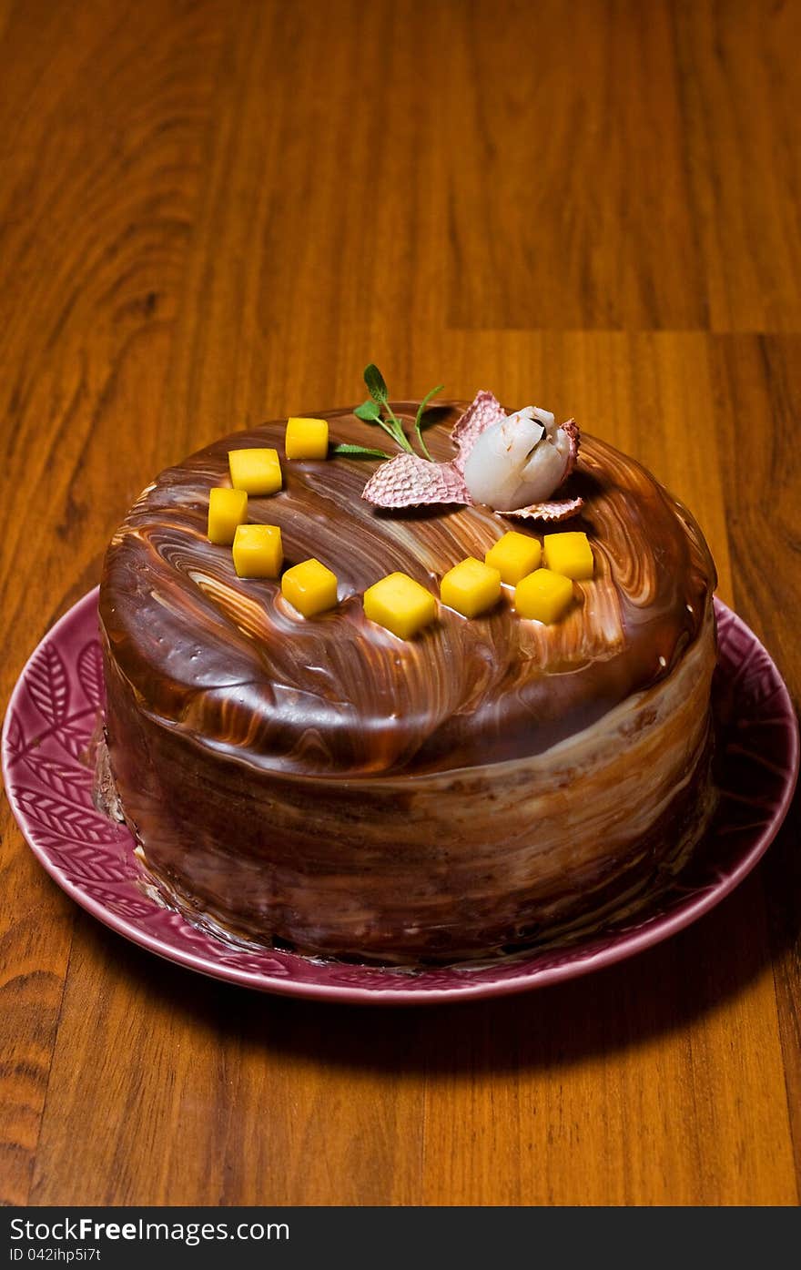 Chocolate layer cake on a wooden surface