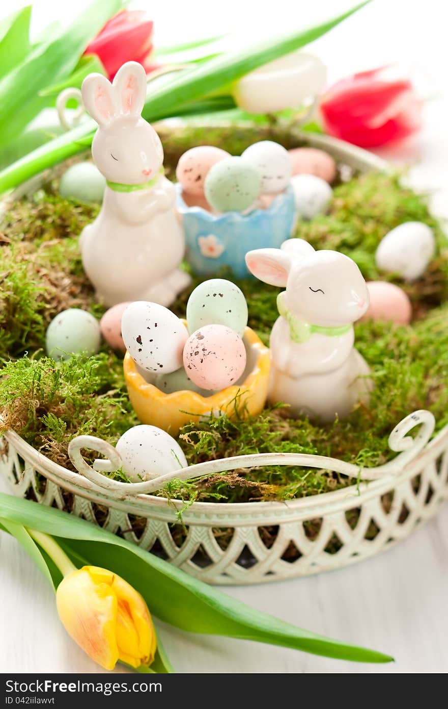 Easter decoration with bunny and chocolate eggs on moss. Easter decoration with bunny and chocolate eggs on moss