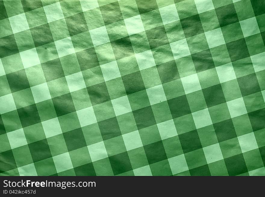 It is a texture of an old paper in green  cell. A background in style of a retro. It is a texture of an old paper in green  cell. A background in style of a retro