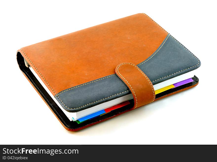 Notebook with a suede cover is brown in color against a white background. Notebook with a suede cover is brown in color against a white background