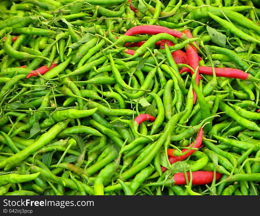 Pile of green and red chilli peppers