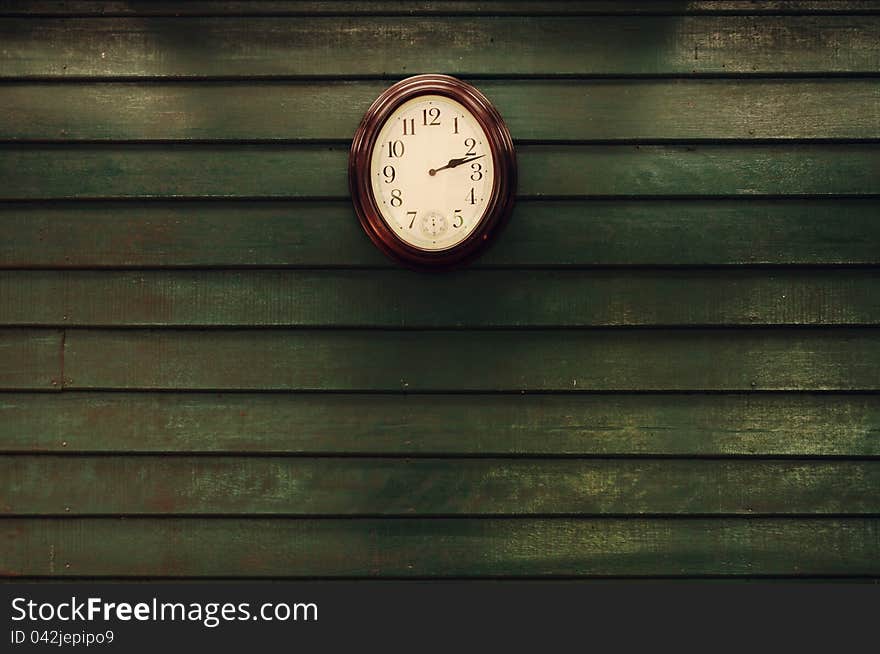 Old green wooden wall and old clock. Old green wooden wall and old clock