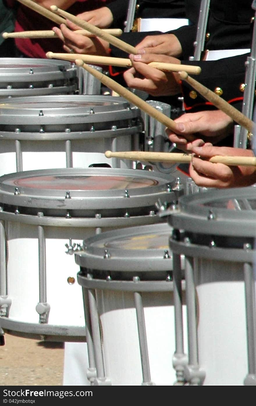 Close up of a  celtic drum group lined up with sticks and drums in hand. Close up of a  celtic drum group lined up with sticks and drums in hand