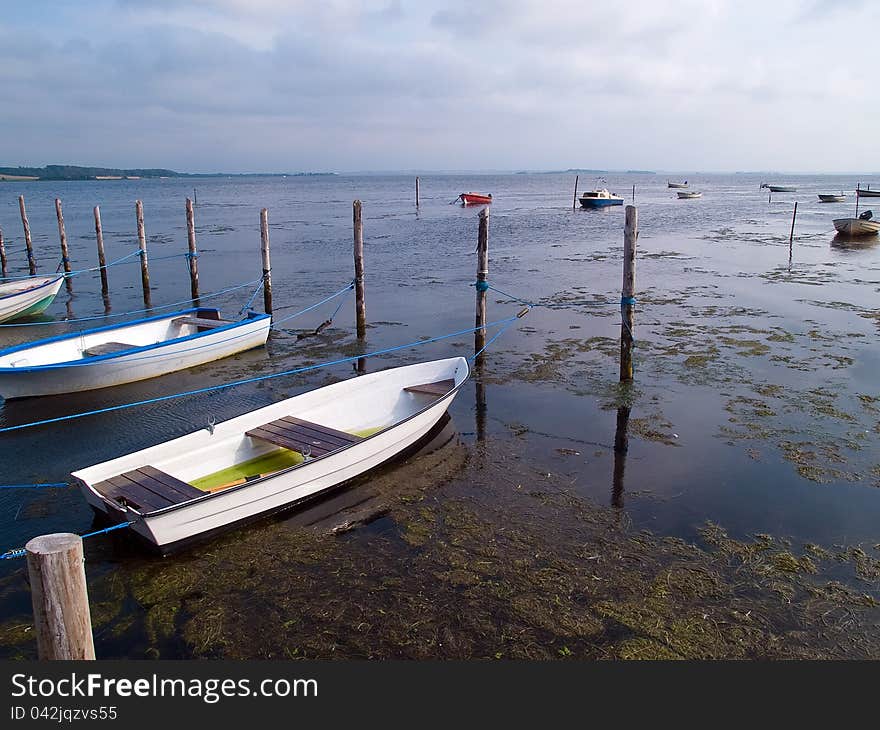 Small dinghy doryfishing boats moored in traditional small marina Denmark. Small dinghy doryfishing boats moored in traditional small marina Denmark