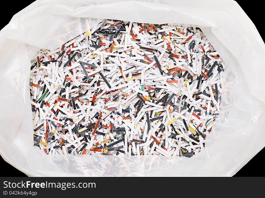 Shredded paper in plastic trash bag