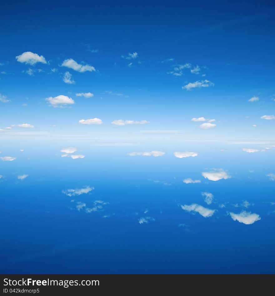 Beautiful blue sky background reflected in water. Beautiful blue sky background reflected in water