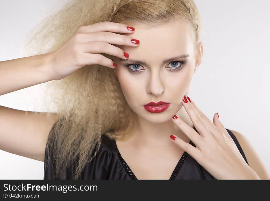 Young pretty woman with beautiful blond hairs and multicolor makeup on white background