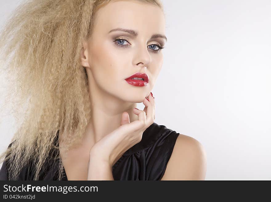 Young pretty woman with beautiful blond hairs and multicolor makeup isolated on white background