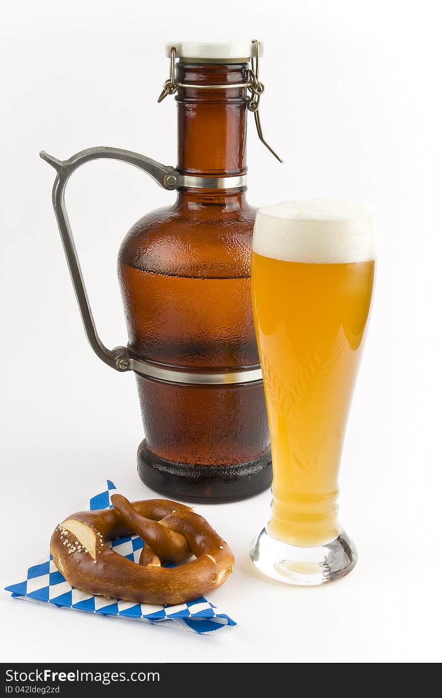 A pretzel, a pitcher of beer and a glass of wheat beer on a white background into. A pretzel, a pitcher of beer and a glass of wheat beer on a white background into.