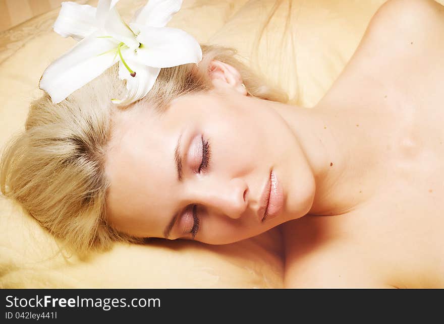 Attractive woman in bed on white background