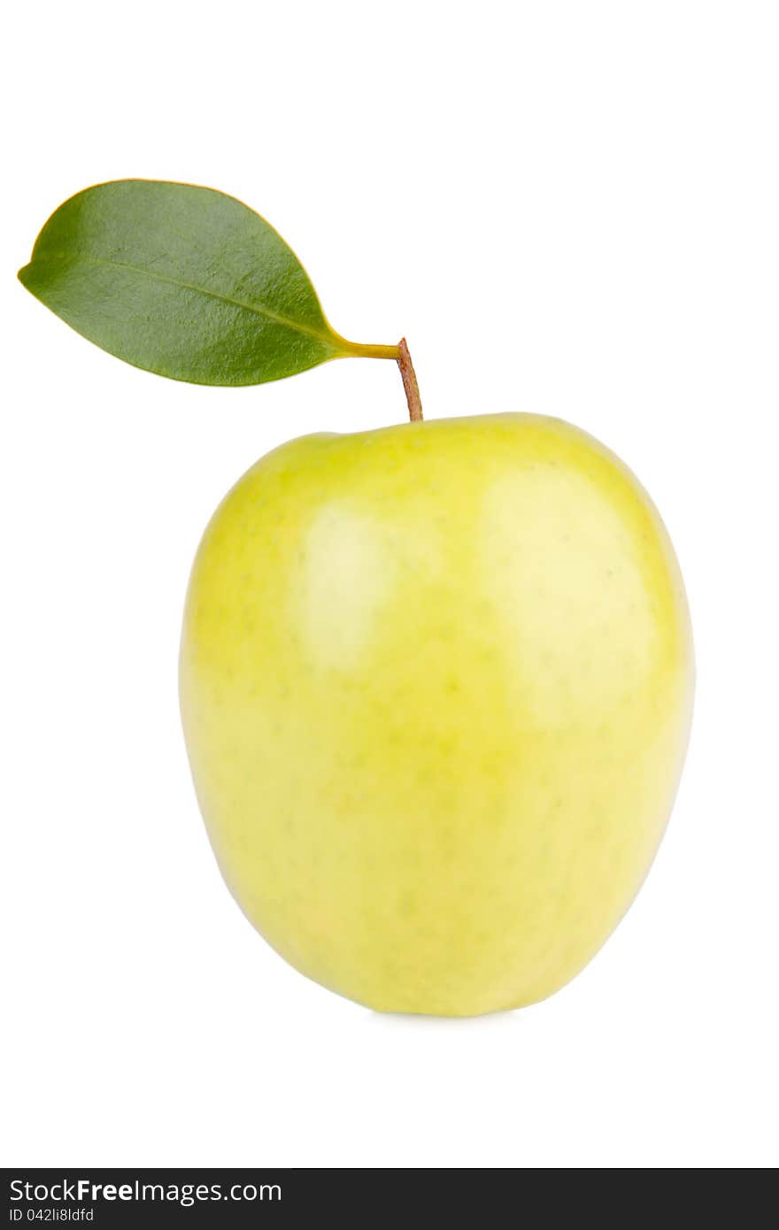 Golden delicious apple with green leaf isolated on white. Golden delicious apple with green leaf isolated on white