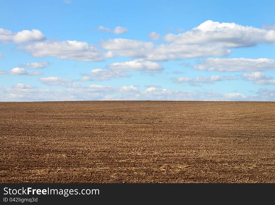 Ploughed field and cloudy sky