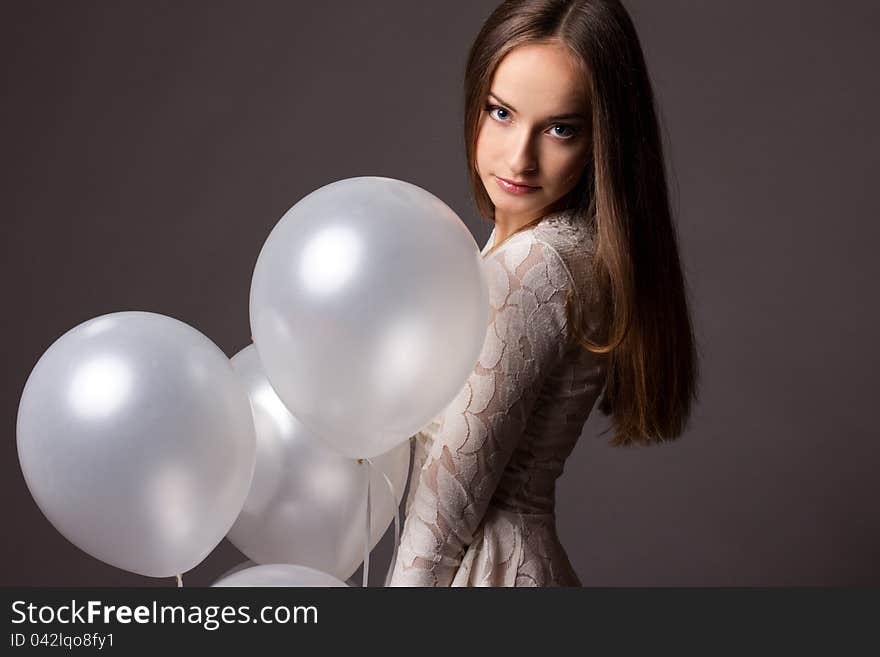 Woman in studio with white balloons