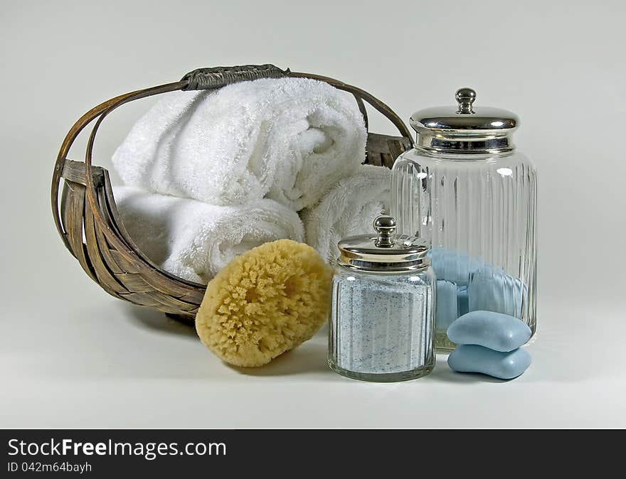 Items used in a luxurious bath, soft towels, scented soap, bath salts, and a sponge. Items used in a luxurious bath, soft towels, scented soap, bath salts, and a sponge