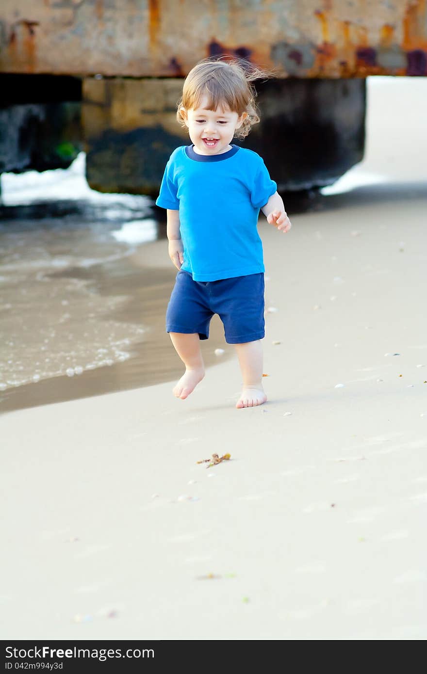 Little boy running on the beach of sea. Little boy running on the beach of sea