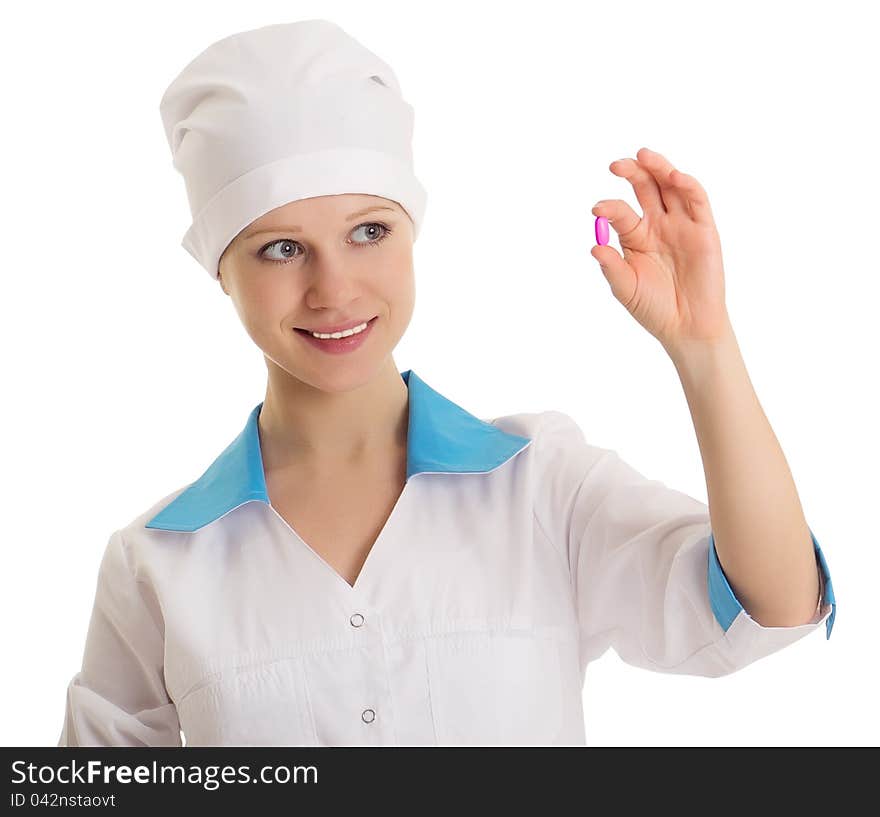 Beautiful nurse holding a pill isolated on white background