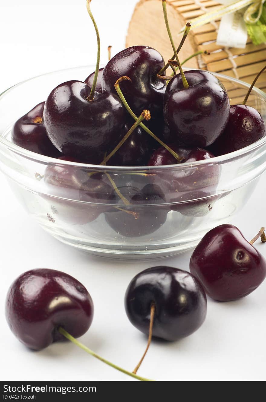 Ripe fresh cherry in the glass bowl