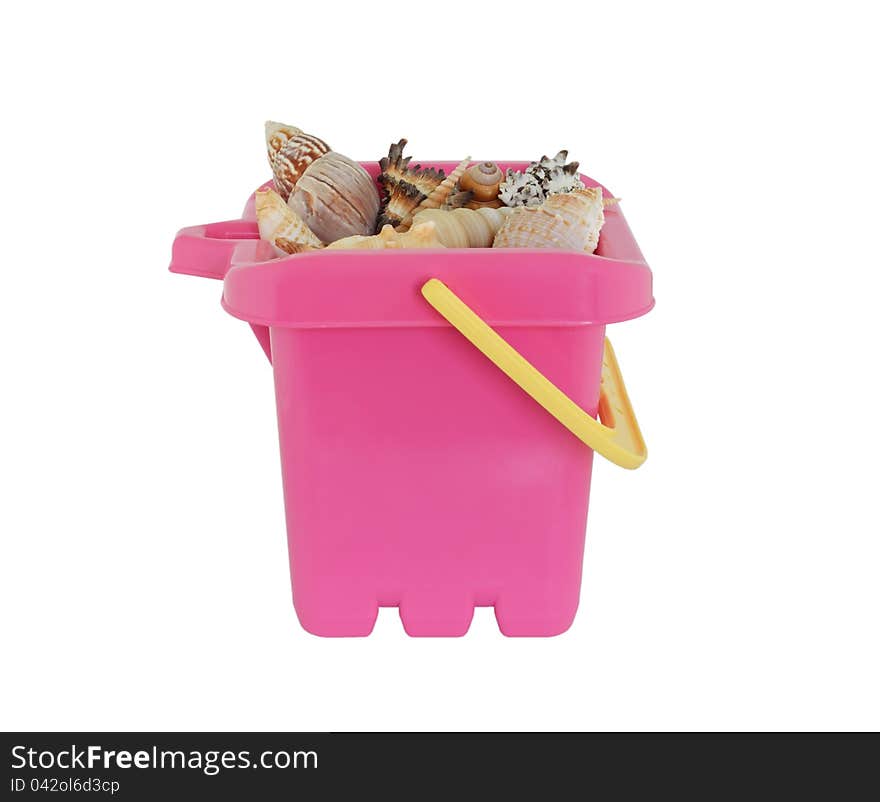 Pink beach bucket with sea shells, isolated on white background. Pink beach bucket with sea shells, isolated on white background