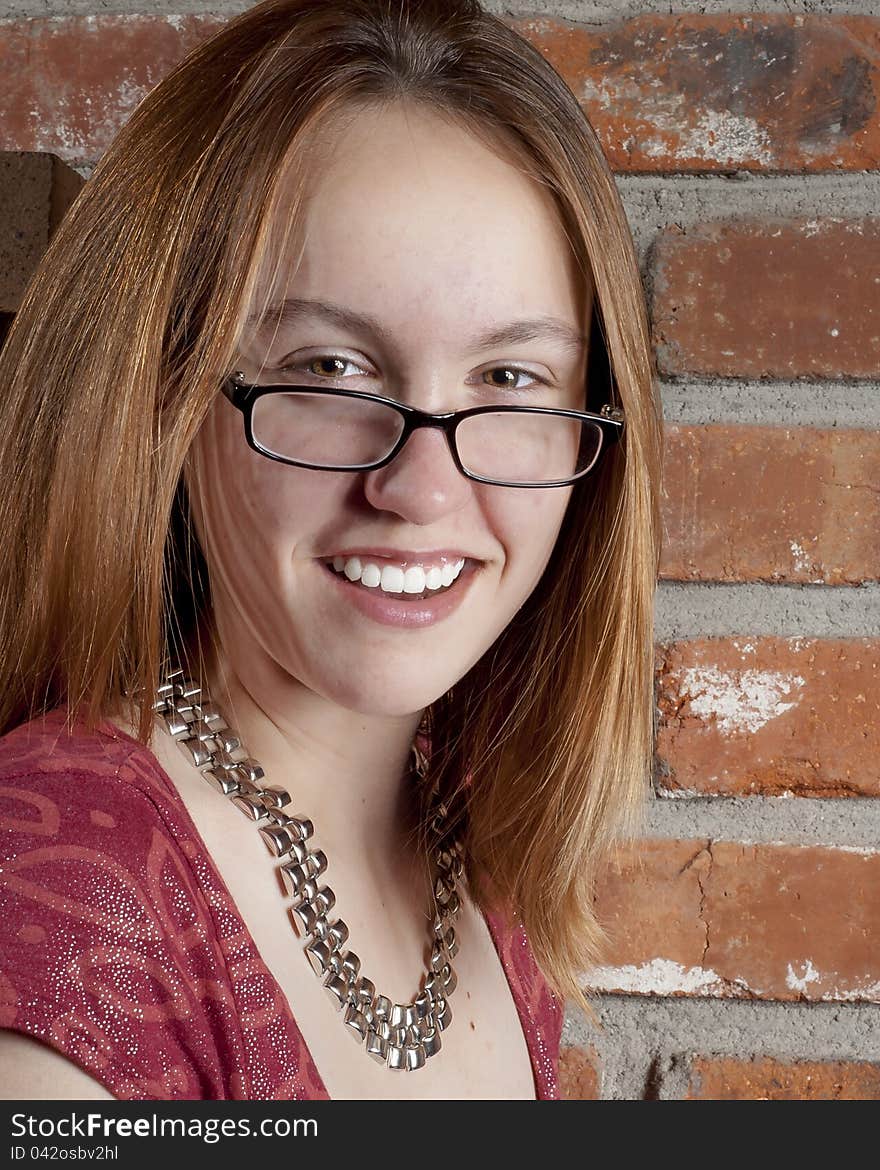 Smiling girl at the camera with her glasses. Smiling girl at the camera with her glasses