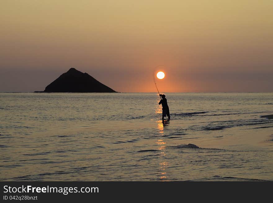 Fisherman at sunrise in hawaii