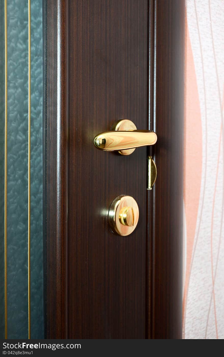 Chrome handle on wooden door. Chrome handle on wooden door