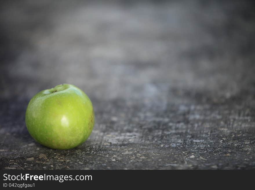 Green fresh juicy apple is on the invoice table. Green fresh juicy apple is on the invoice table