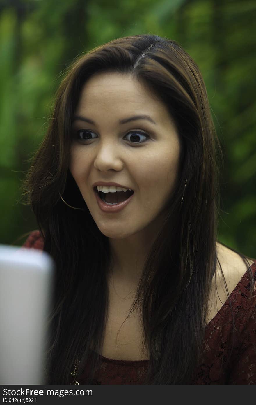 Portrait of a beautiful young woman with her laptop outdoors