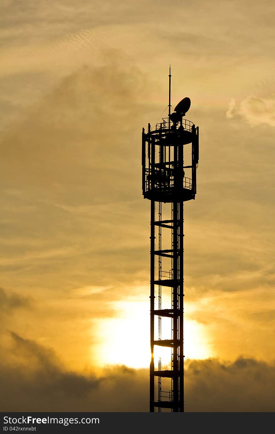 Silhouette of mobile phone antenna in orange sunset, in Japan