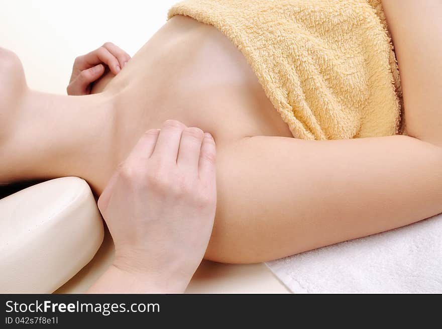 Massage the clavicle, a young woman isolated on white background