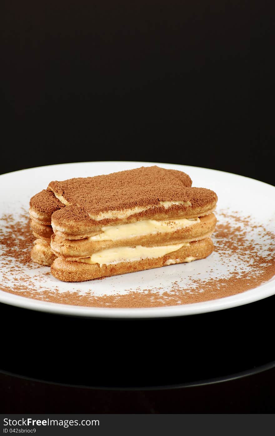 Cake on the white plate and black background