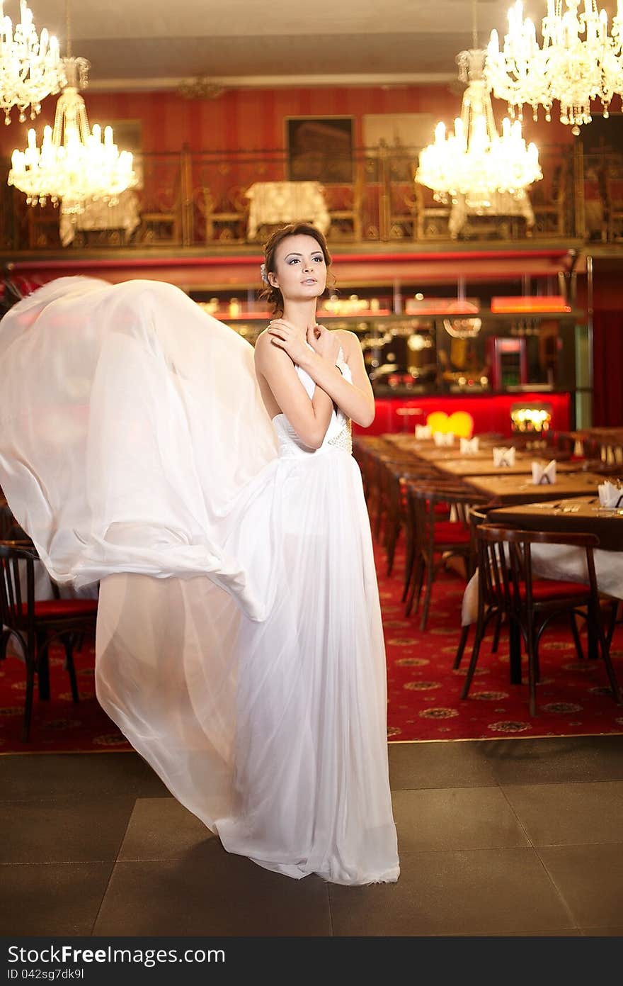 Bride In Flying Wedding Dress In The Restaurant