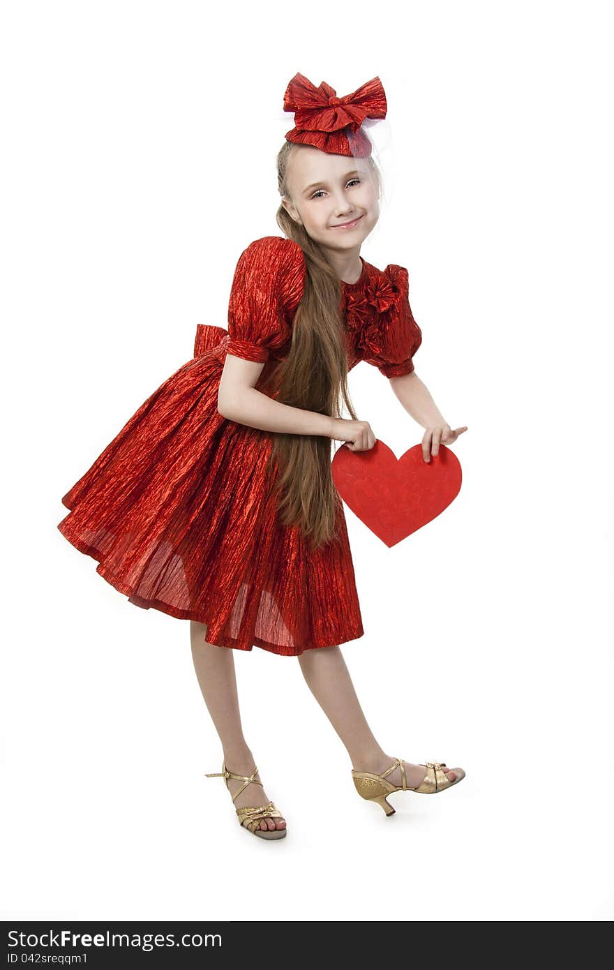 Small playful girl standing with heart in her hands, symbolizing love. Small playful girl standing with heart in her hands, symbolizing love