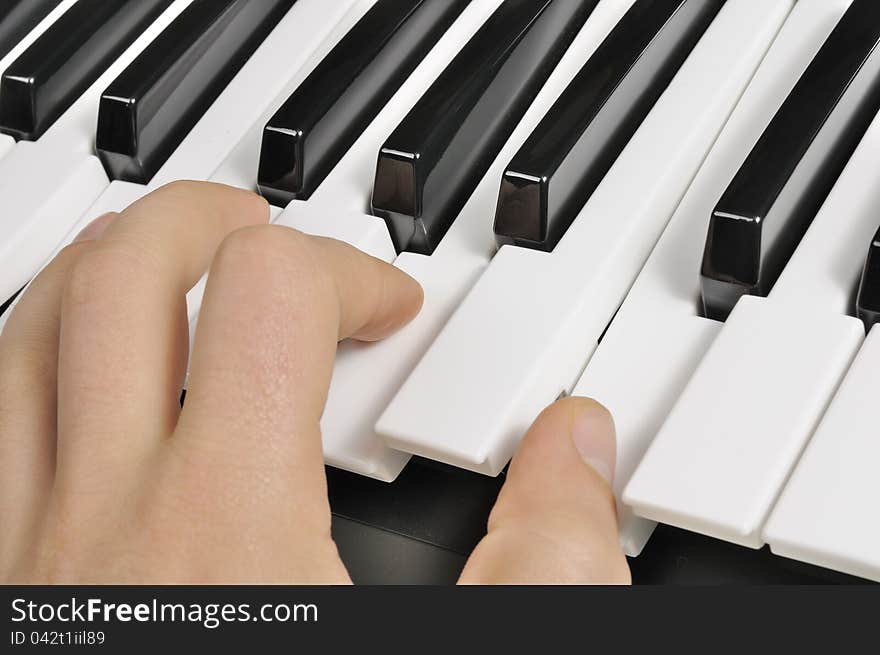 The hand of a musician playing the piano (MIDI keyboard). The hand of a musician playing the piano (MIDI keyboard)