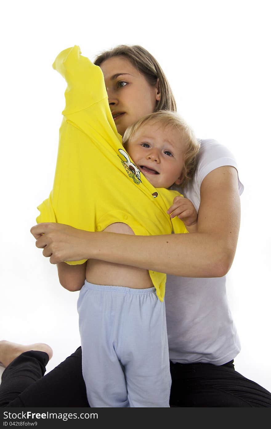 Careful mother dresses the son. Isolated on white. Careful mother dresses the son. Isolated on white.