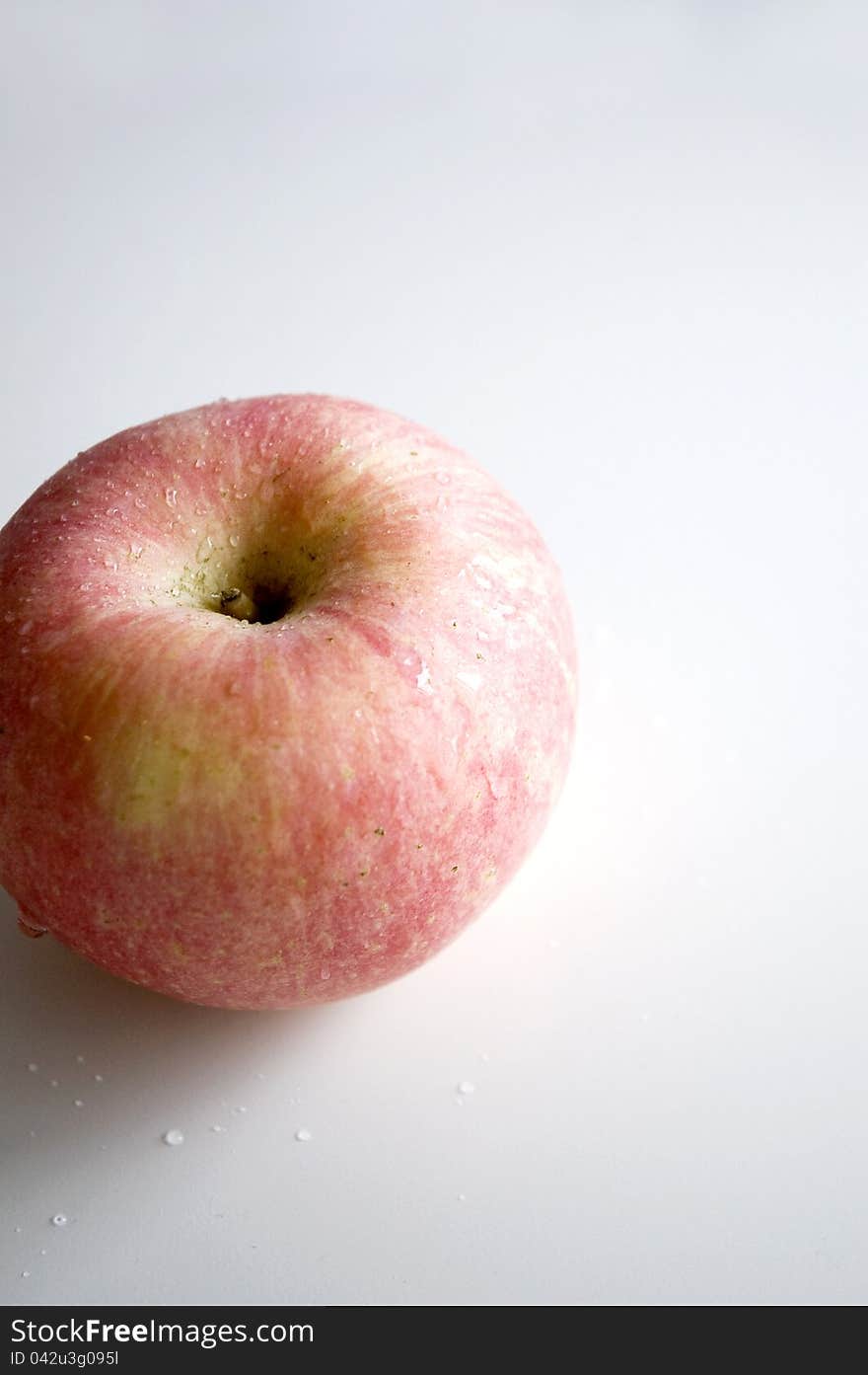 Fresh pink apple on white background