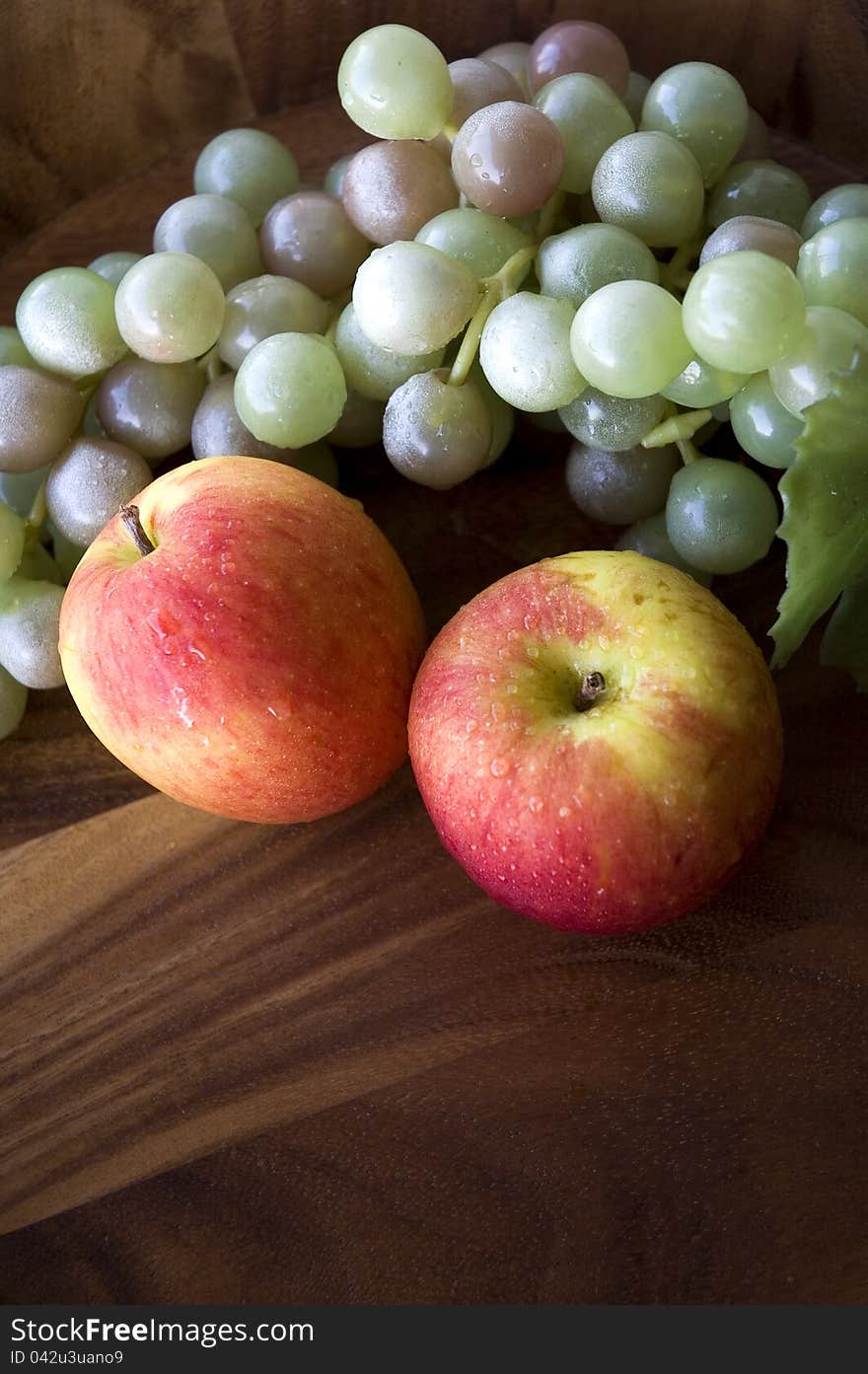 Apples and grapes in wooden tray on top view. Apples and grapes in wooden tray on top view