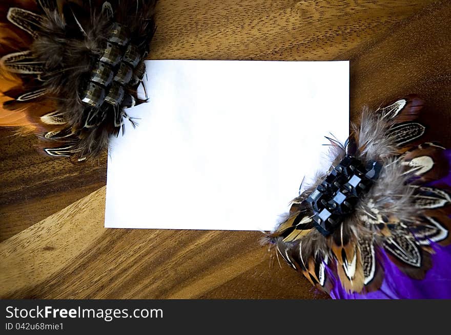 White space for text put on wood decorated with colorful feathers. White space for text put on wood decorated with colorful feathers