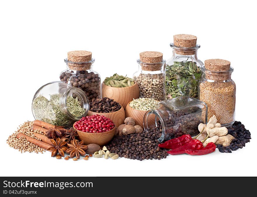 Still life of different spices and herbs on white background