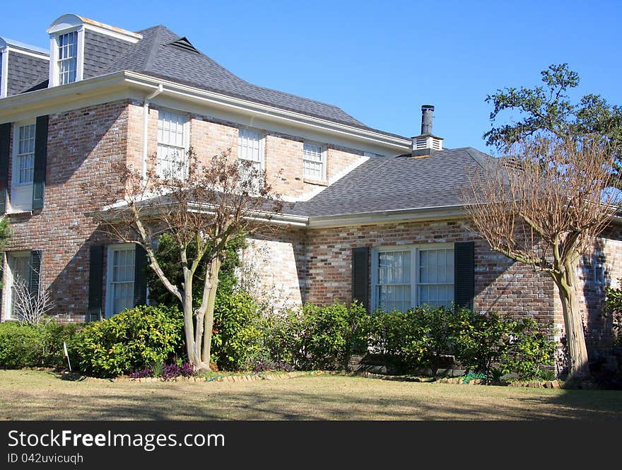 Suburban Brick House With Plants