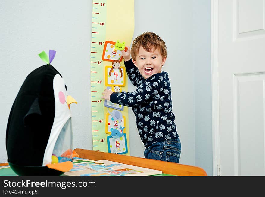 Little boy age 3 laughing and playing in his room. Little boy age 3 laughing and playing in his room