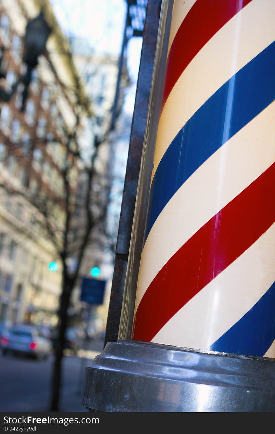 Barber pole with blurred city background