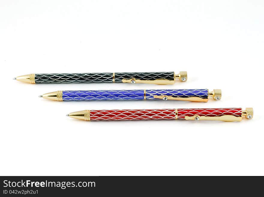 Three color ballpoint pens on a white background