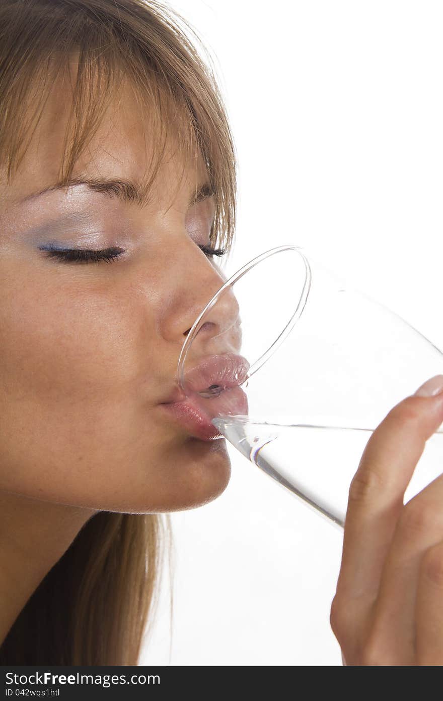 Young woman holds glass against the white background. Young woman holds glass against the white background