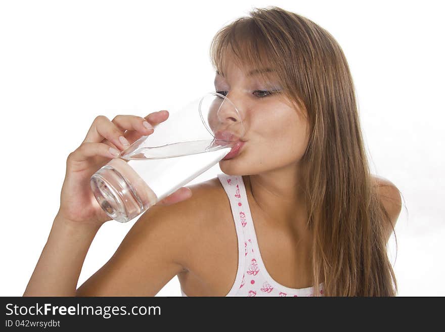 Young woman holds glass against the white background. Young woman holds glass against the white background