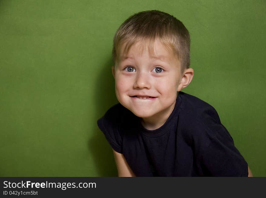 Portrait of the surprise boy on a green background. Portrait of the surprise boy on a green background